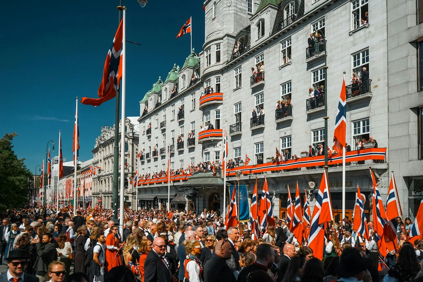 Norwegian Constitution Day celebration with flags and traditional bunad costumes