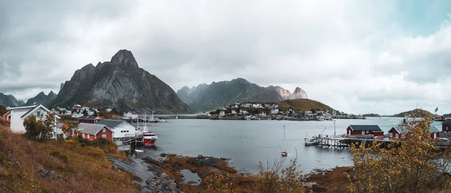 Red fishing cabins at Reine with dramatic Lofoten peaks behind