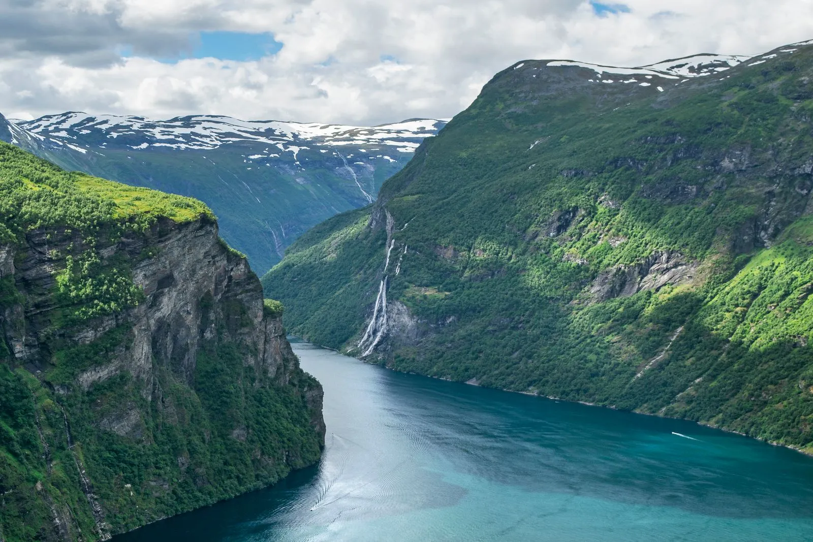 Geirangerfjord with waterfalls cascading down steep green mountains