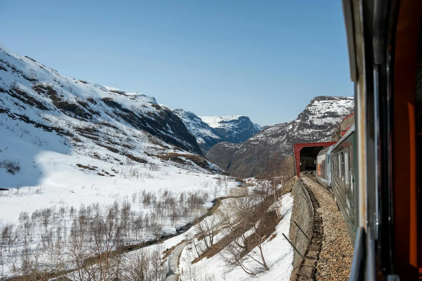 Norwegian train crossing a bridge over a fjord