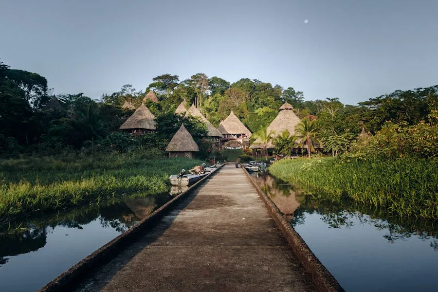 Traditional Ember&aacute; thatched huts along a jungle riverbank