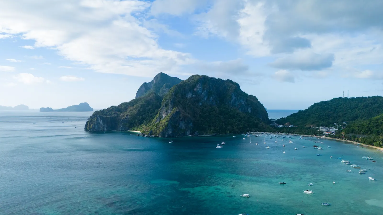 Explore the stunning El Nido island with turquoise waters and lush karst cliffs.