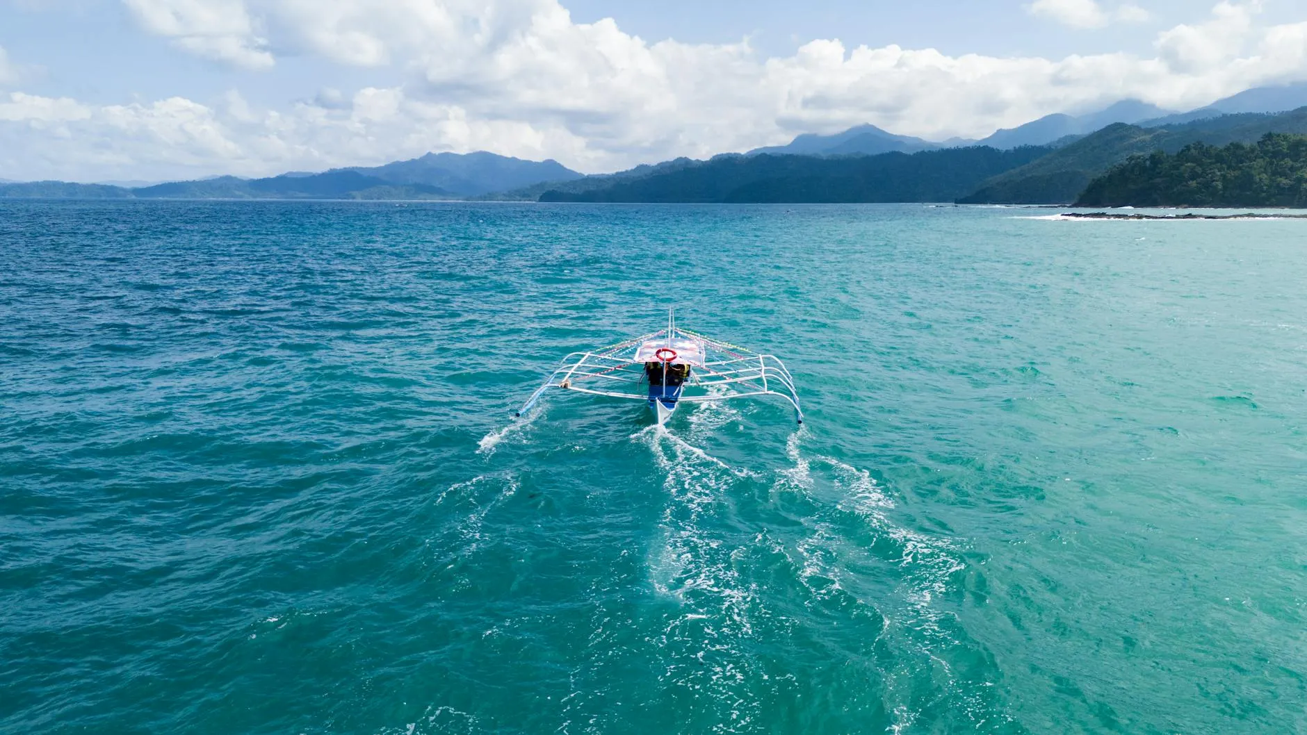 Drone captures a traditional boat navigating the turquoise waters of Mimaropa, Philippines.