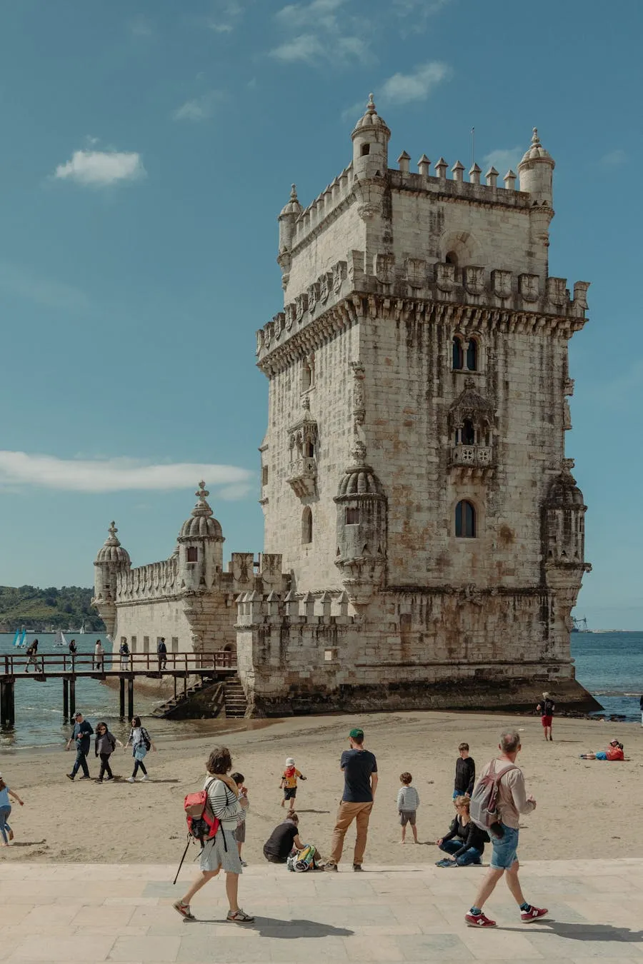 Tower of Belem standing on the Tagus riverbank at golden hour