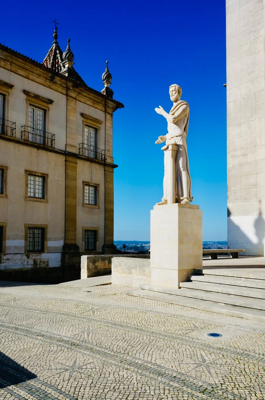 Historic facade of the University of Coimbra with bell tower