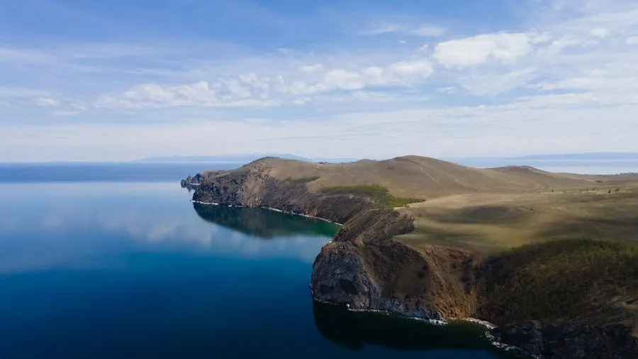 Lake Baikal shoreline with crystal clear water and forested hills