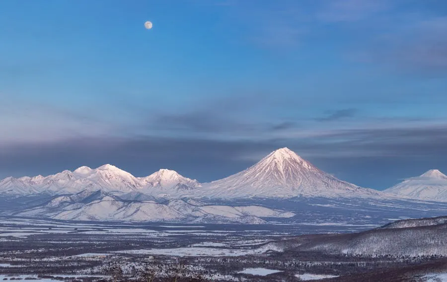 Kamchatka volcanic landscape with steaming crater and snow