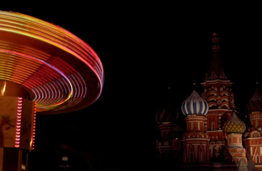 Red Square at dusk with the Kremlin walls and St Basil Cathedral illuminated