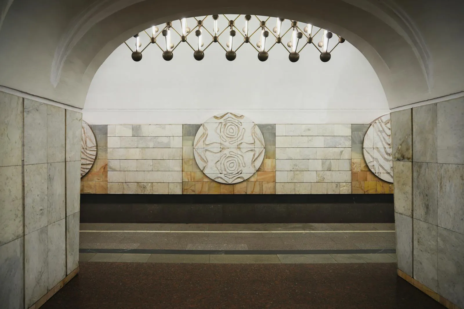 Moscow Metro train arriving at an ornate station with marble and chandeliers