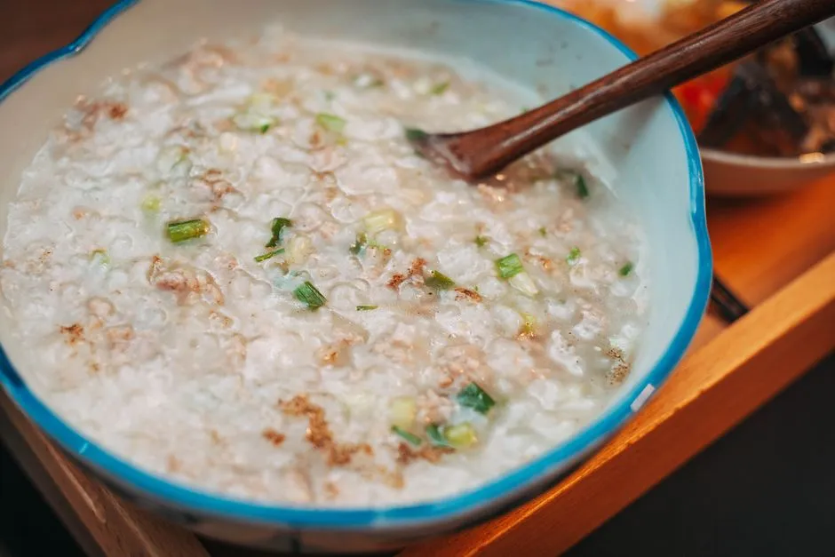 Creamy saleeg rice porridge topped with roasted chicken