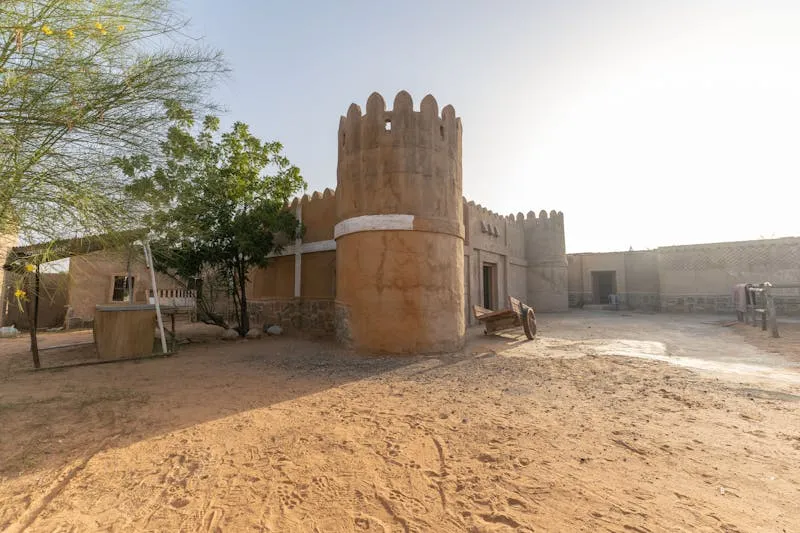 Traditional sandstone fortress with towers in desert landscape