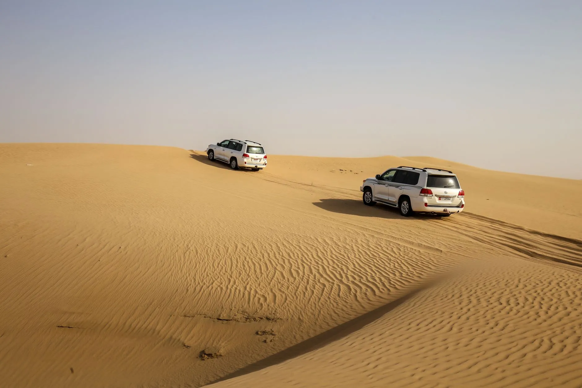 Dune bashing in the red sands of the Empty Quarter at golden hour