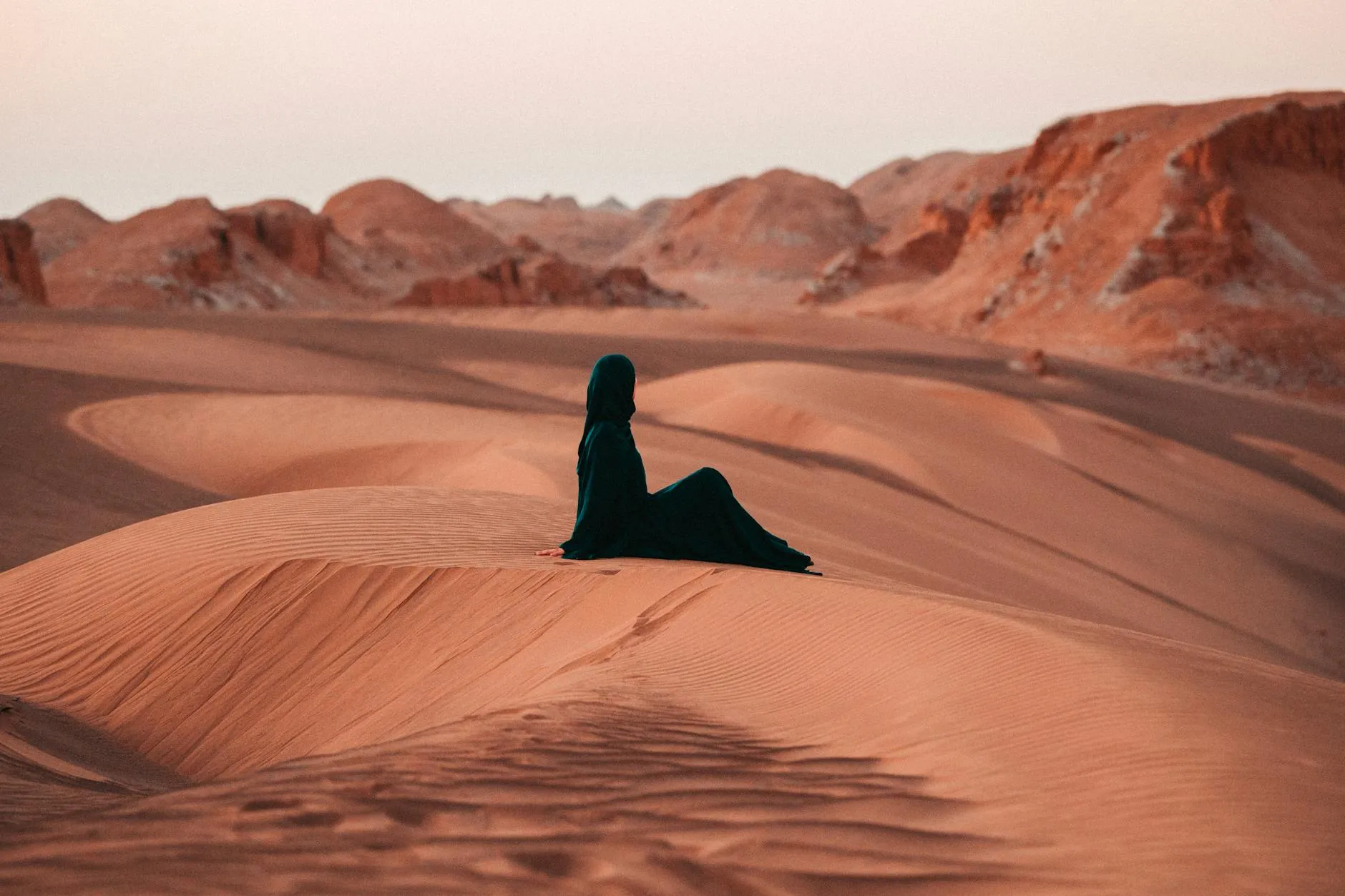 Golden light over desert dunes at sunset in Saudi Arabia