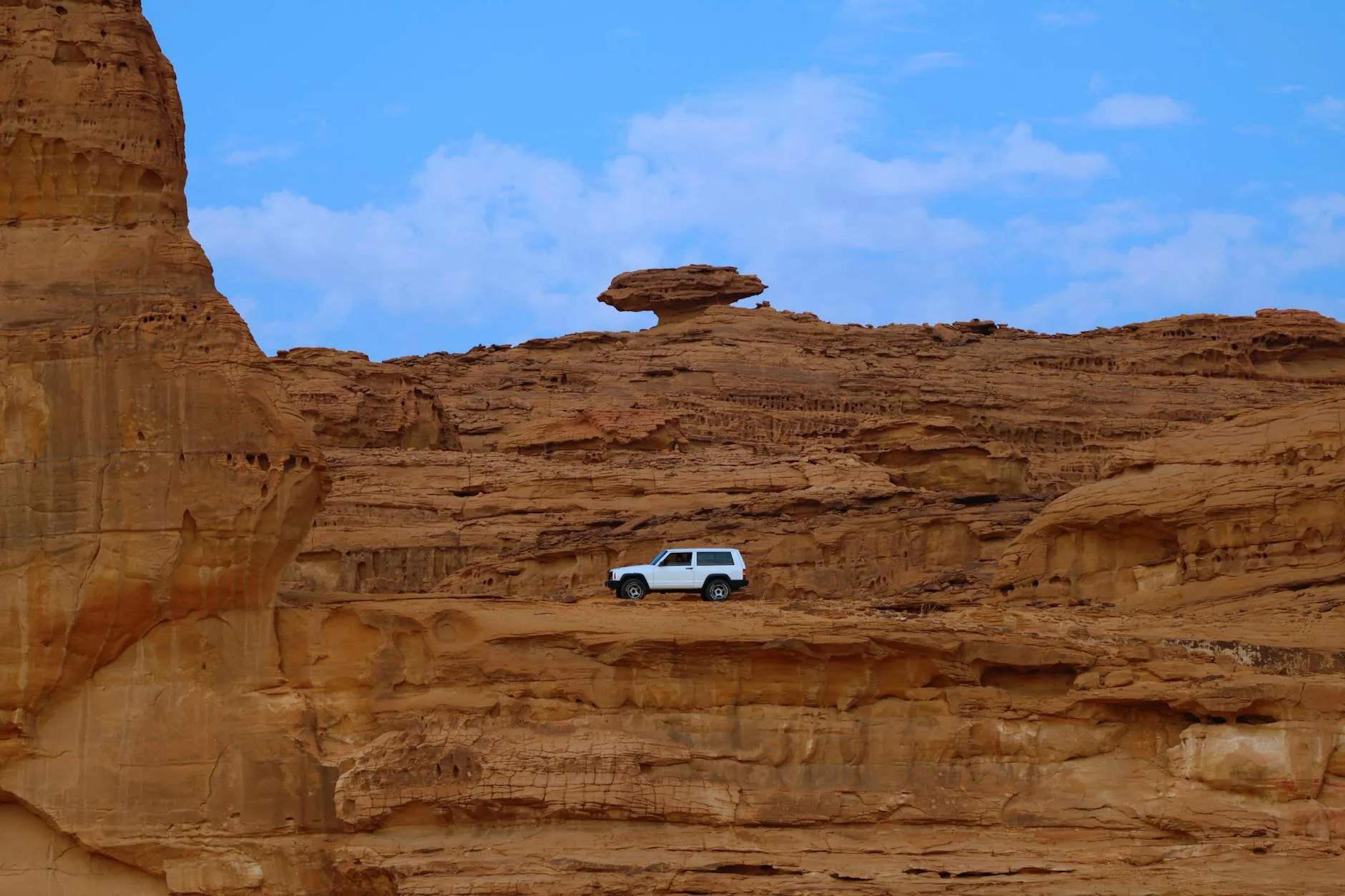 View across AlUla valley with sandstone formations and palm oasis