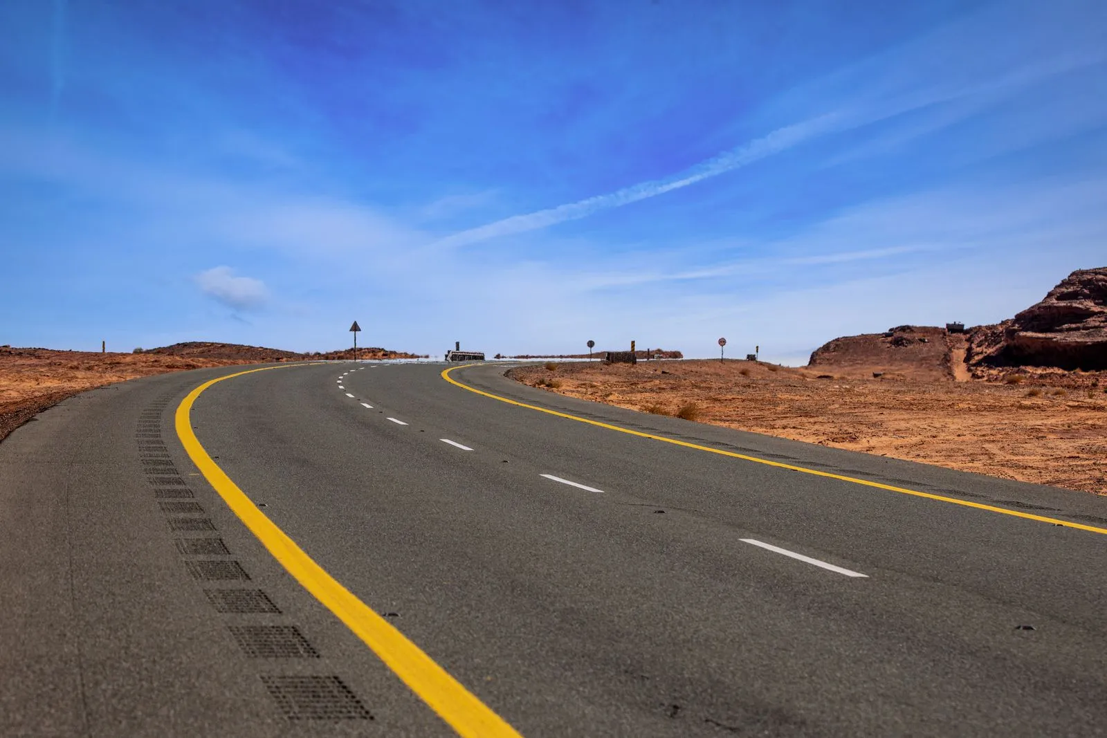 Scenic curved road cutting through the desert landscape in Tayma, Saudi Arabia