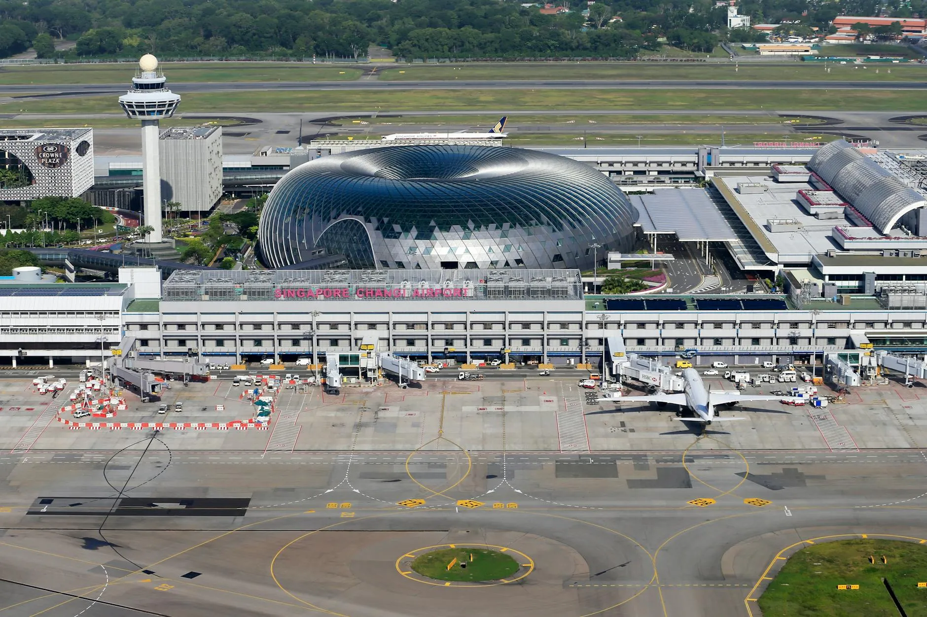 Aerial view of Singapore Changi Airport, showcasing modern architecture and bustling airport activity.
