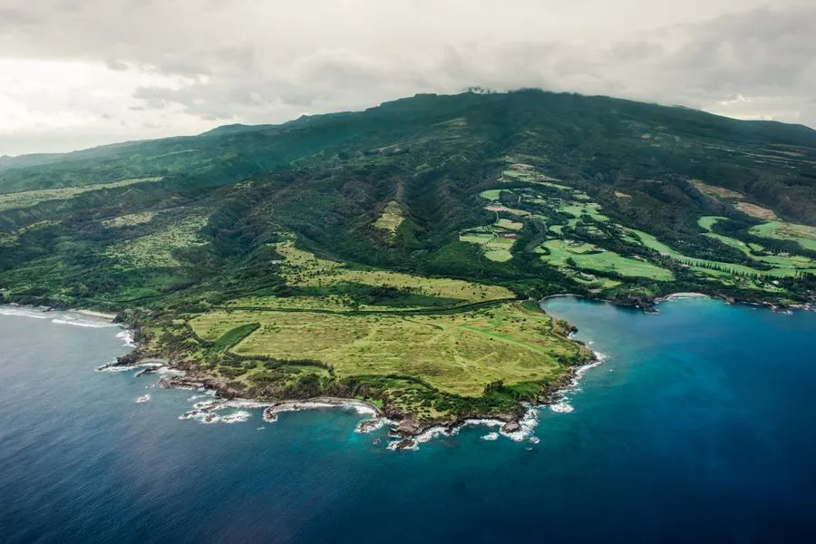 Rolling green hills meeting dramatic coastline