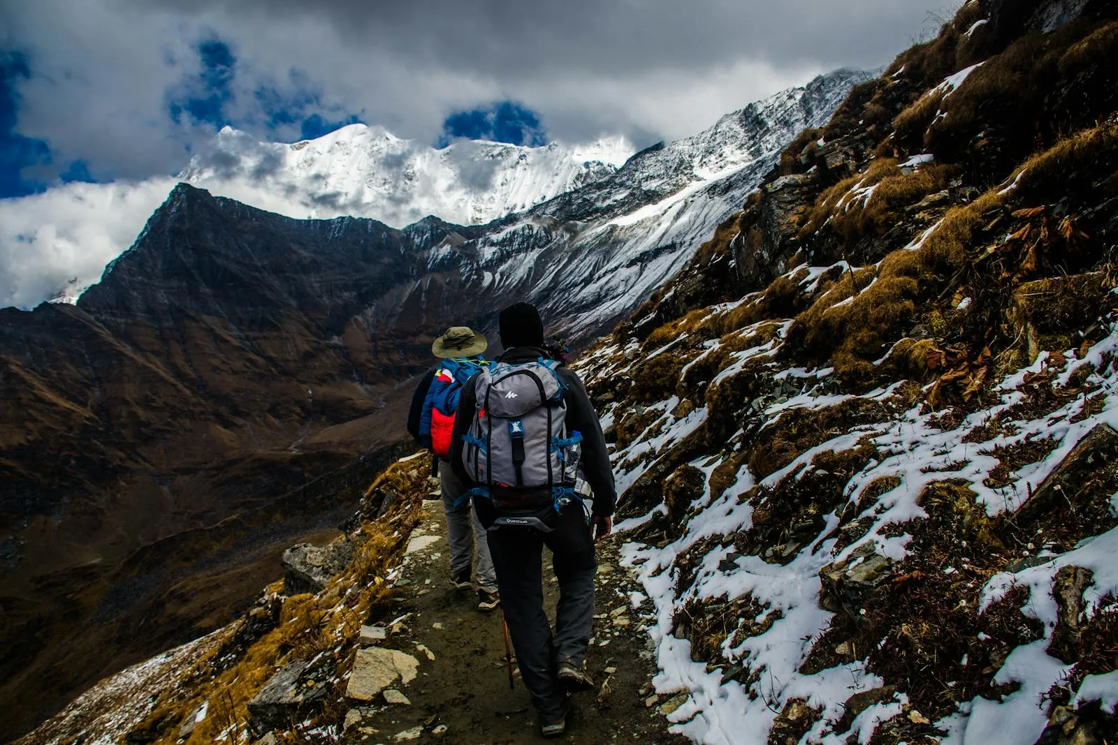 Hikers on a mountain trail with dramatic views