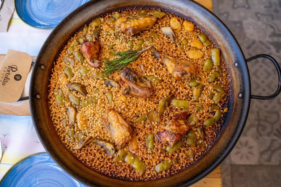 Traditional Valencian paella cooking over an open flame