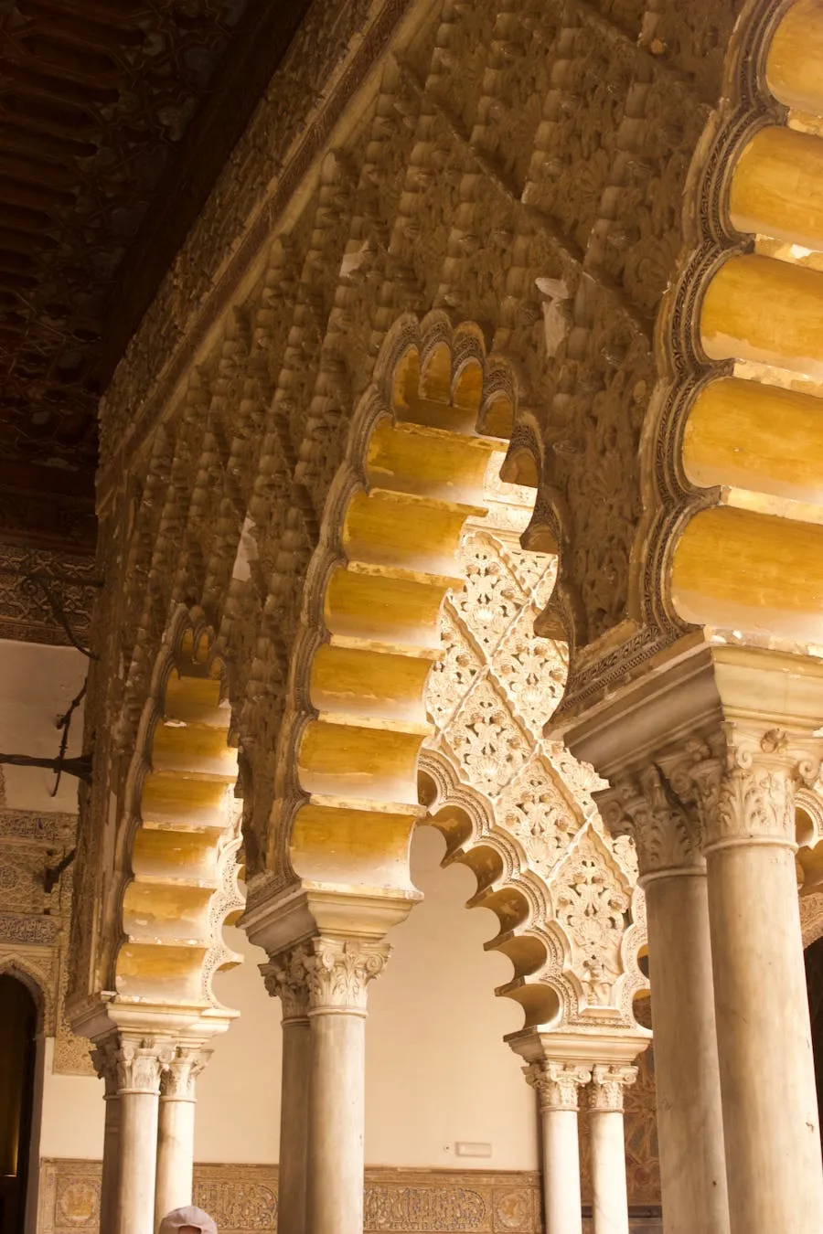 Intricate Moorish archways inside the Alcazar of Seville