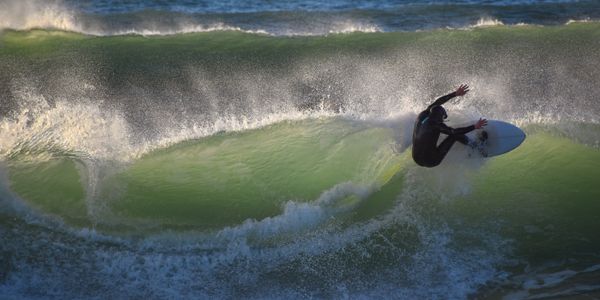 Surfer skillfully rides a wave in the ocean