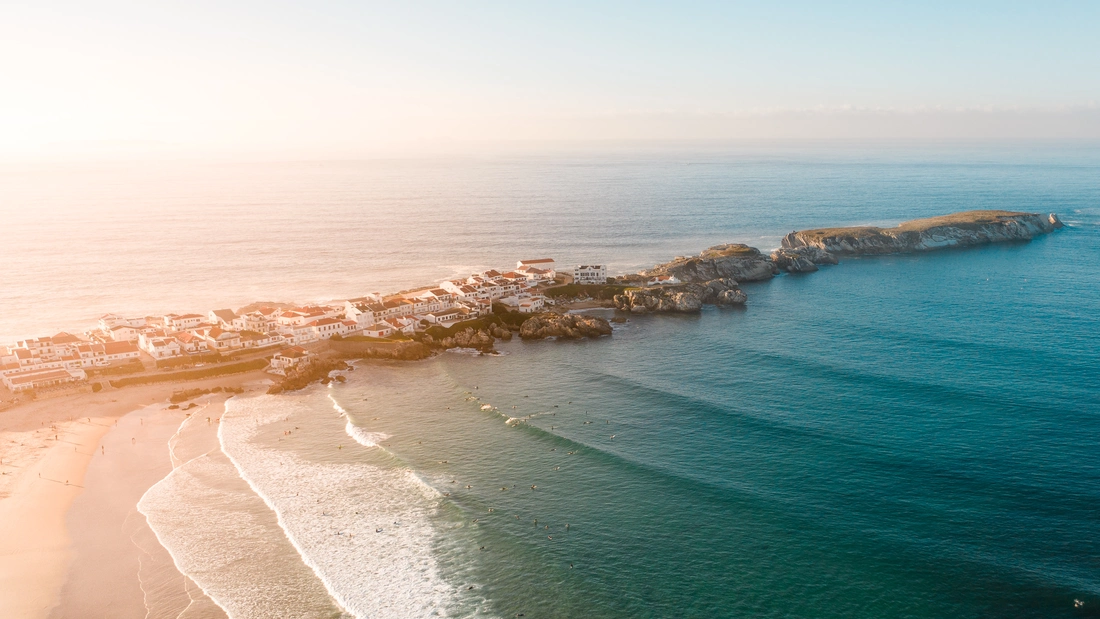 Beach break at Baleal, Portugal — waves breaking over sandbars along a sandy shoreline