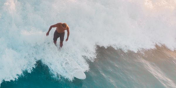 Surfer riding a wave in Canggu, Bali