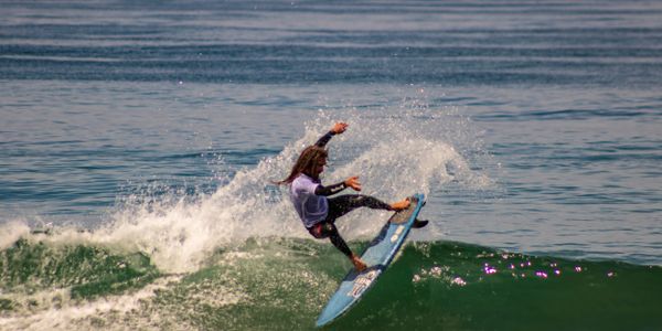 Professional surfer skillfully rides a large ocean wave
