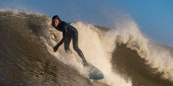 Surfer skillfully rides a wave in the ocean