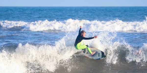Surfer skillfully rides a wave in the ocean