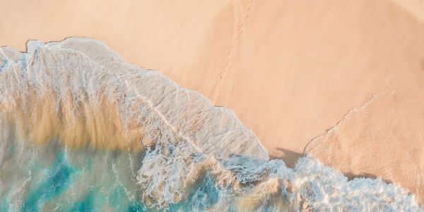 Surfer at the shoreline in Ericeira, Portugal