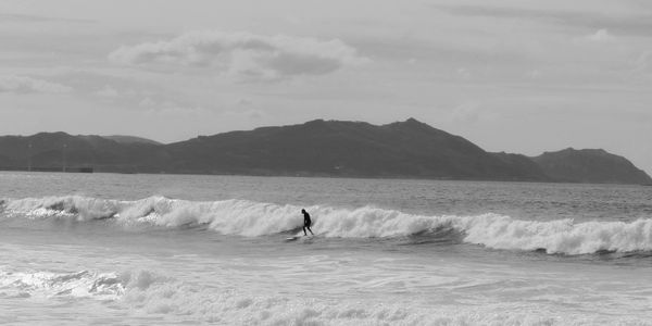 Dynamic aerial maneuver by surfer on beach waves