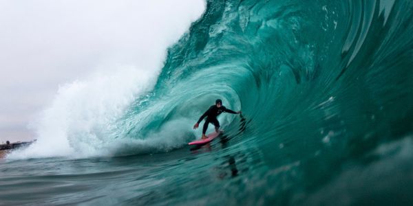 Surfer skillfully riding a powerful wave in the open ocean