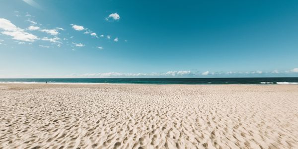 Idyllic sandy beach with clear blue skies on the Gold Coast, Australia