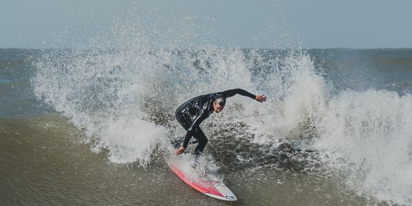 Professional surfer skillfully rides a large ocean wave