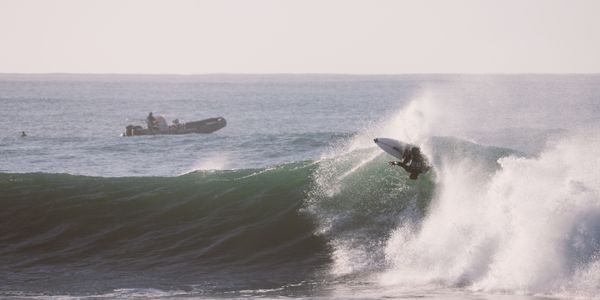 Surfer skillfully rides a powerful wave at Jeffreys Bay, South Africa