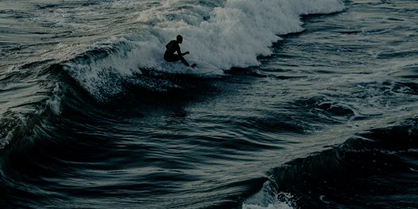 Surfers at sunset in Mimizan, France