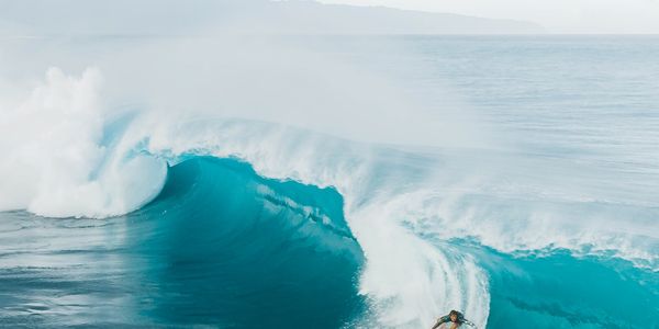 A surfer skillfully rides a large wave at Haleiwa Beach, Oahu, Hawaii