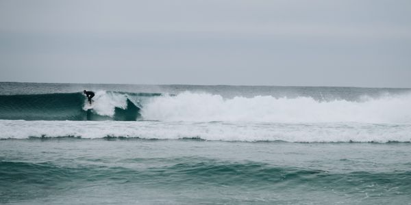 Surfer skillfully riding a powerful wave in the open ocean