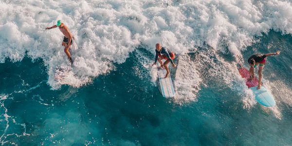 Aerial view of surfers catching waves in Tamarindo, Costa Rica