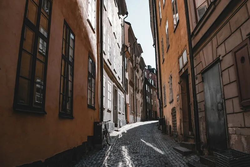 Narrow cobblestone street in Gamla Stan with colourful medieval buildings