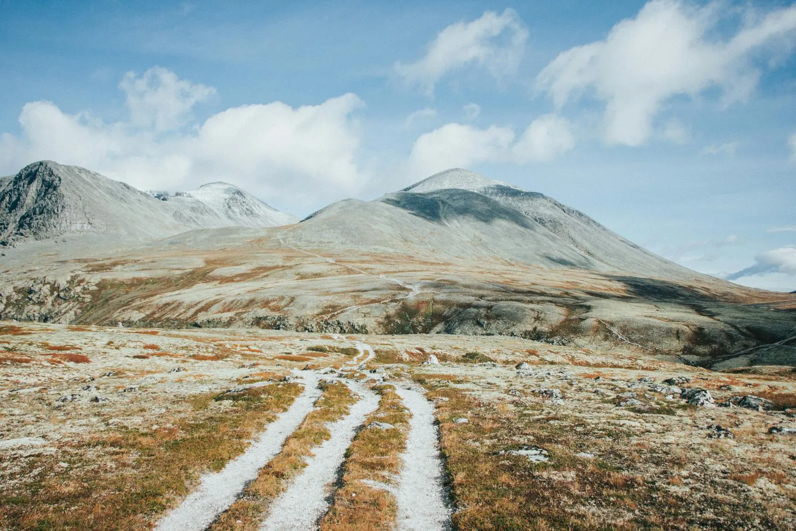 Hiker on a mountain trail overlooking a Scandinavian valley in summer