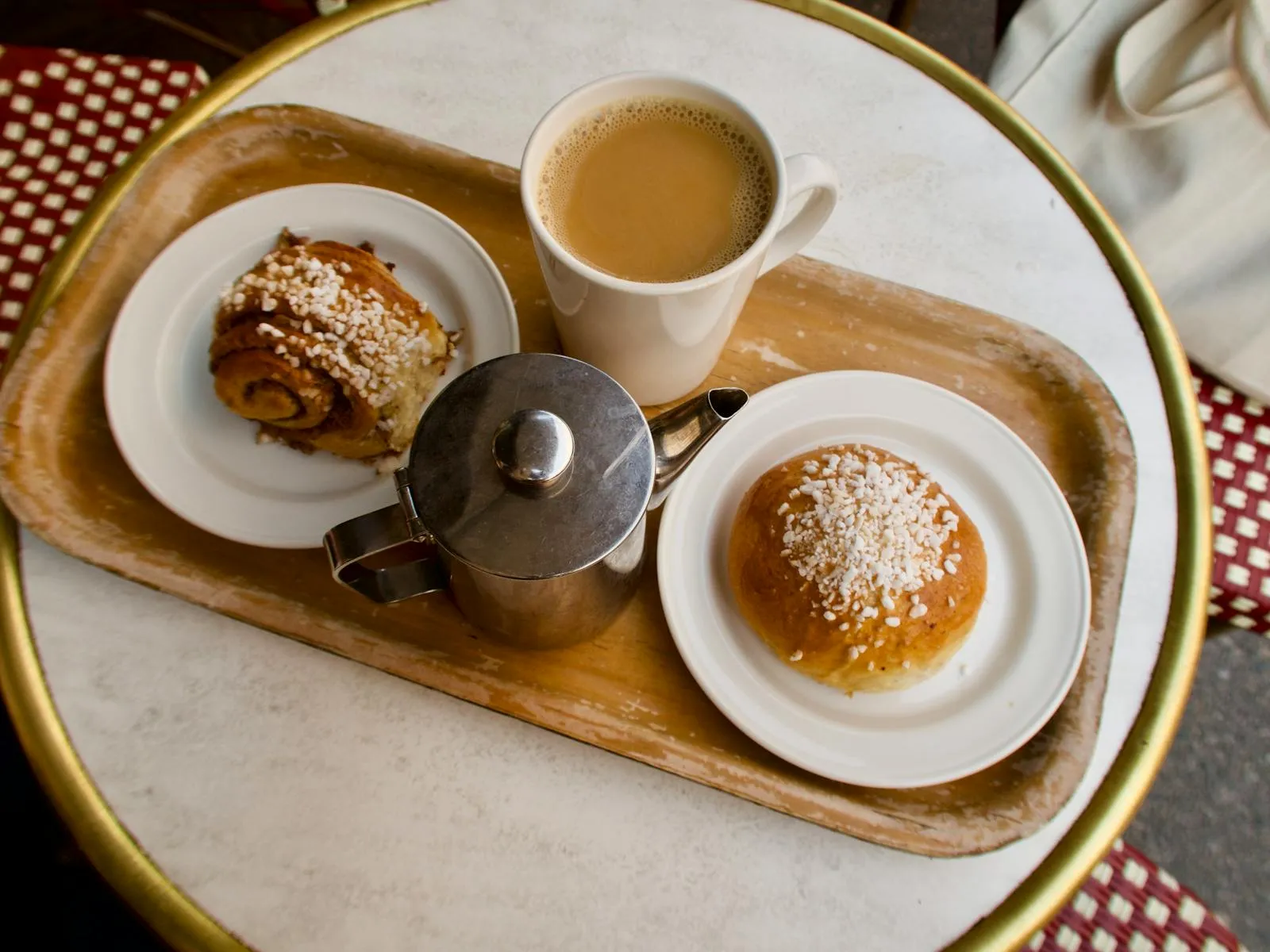 Swedish fika scene with coffee and cinnamon bun on a wooden table