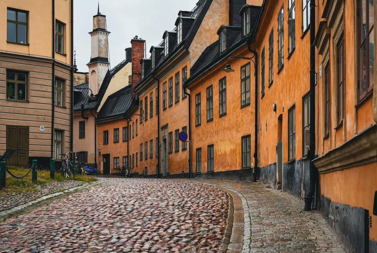Narrow street lined with colourful historic buildings in Gamla Stan, Stockholm