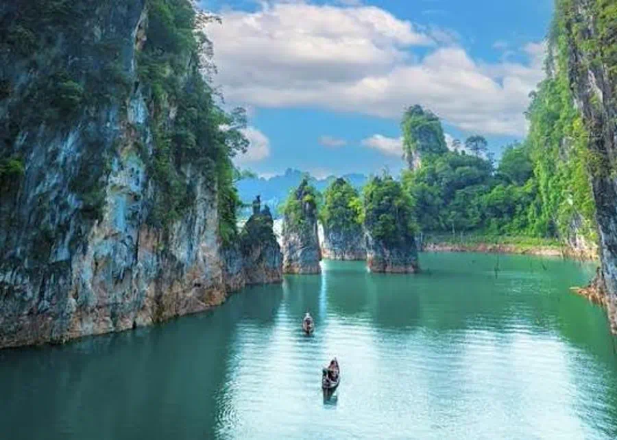 Misty karst peaks reflected in Cheow Lan Lake in Khao Sok