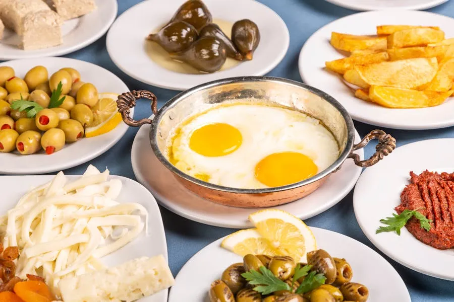 Full Turkish breakfast spread with cheese, olives, eggs, and tea