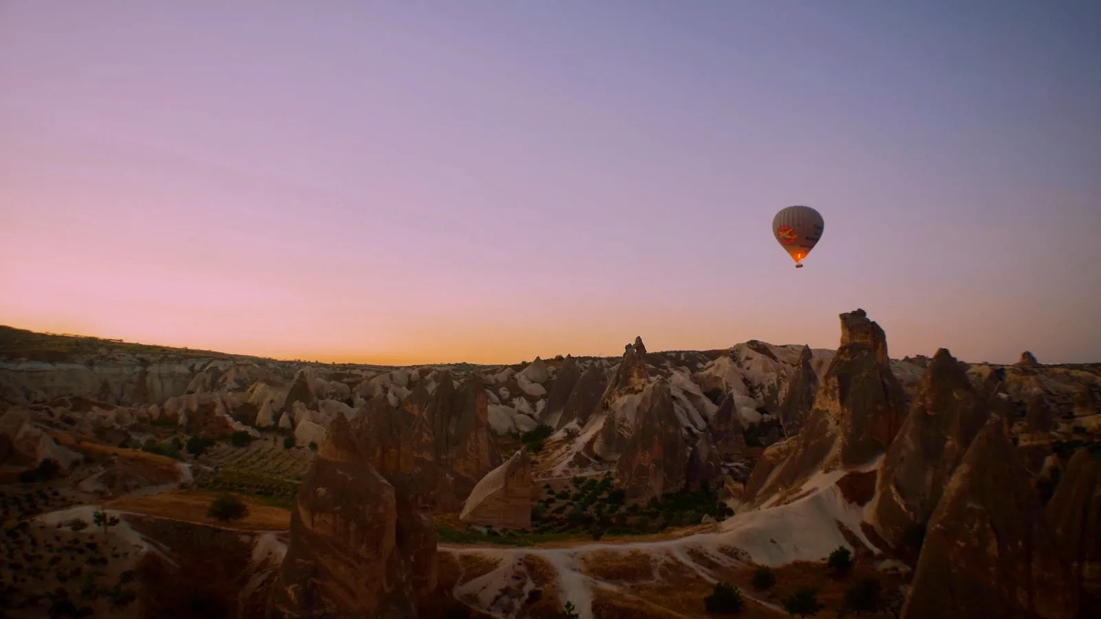 Scenic panoramic view of Cappadocia's fairy chimneys and valleys at sunrise