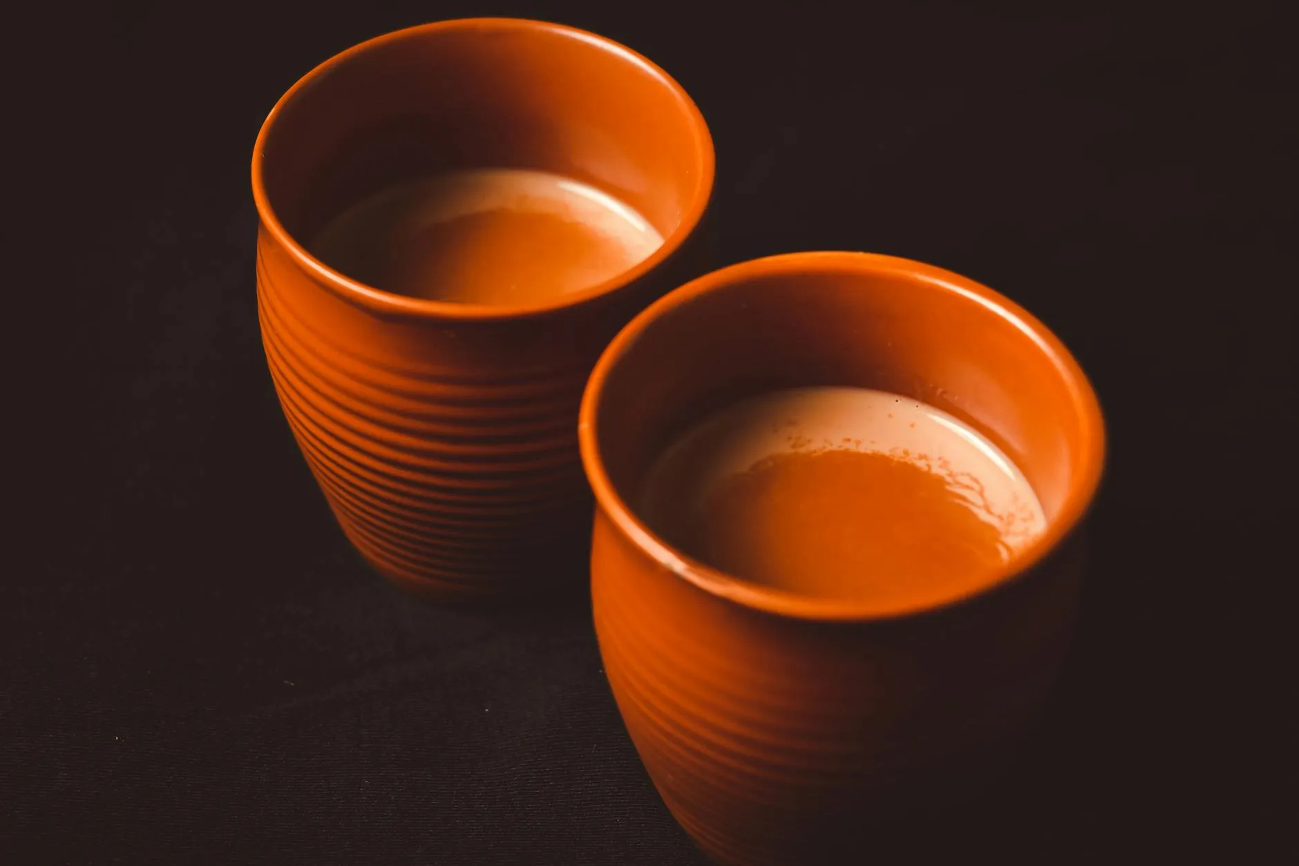 Glass of karak chai tea with frothy top