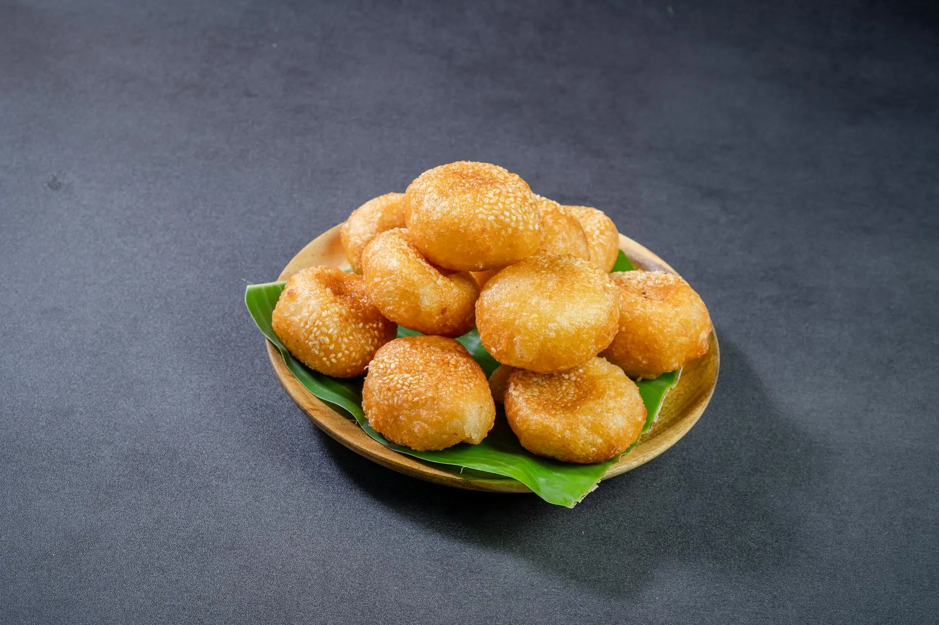 Golden fried luqaimat dough balls drizzled with date syrup
