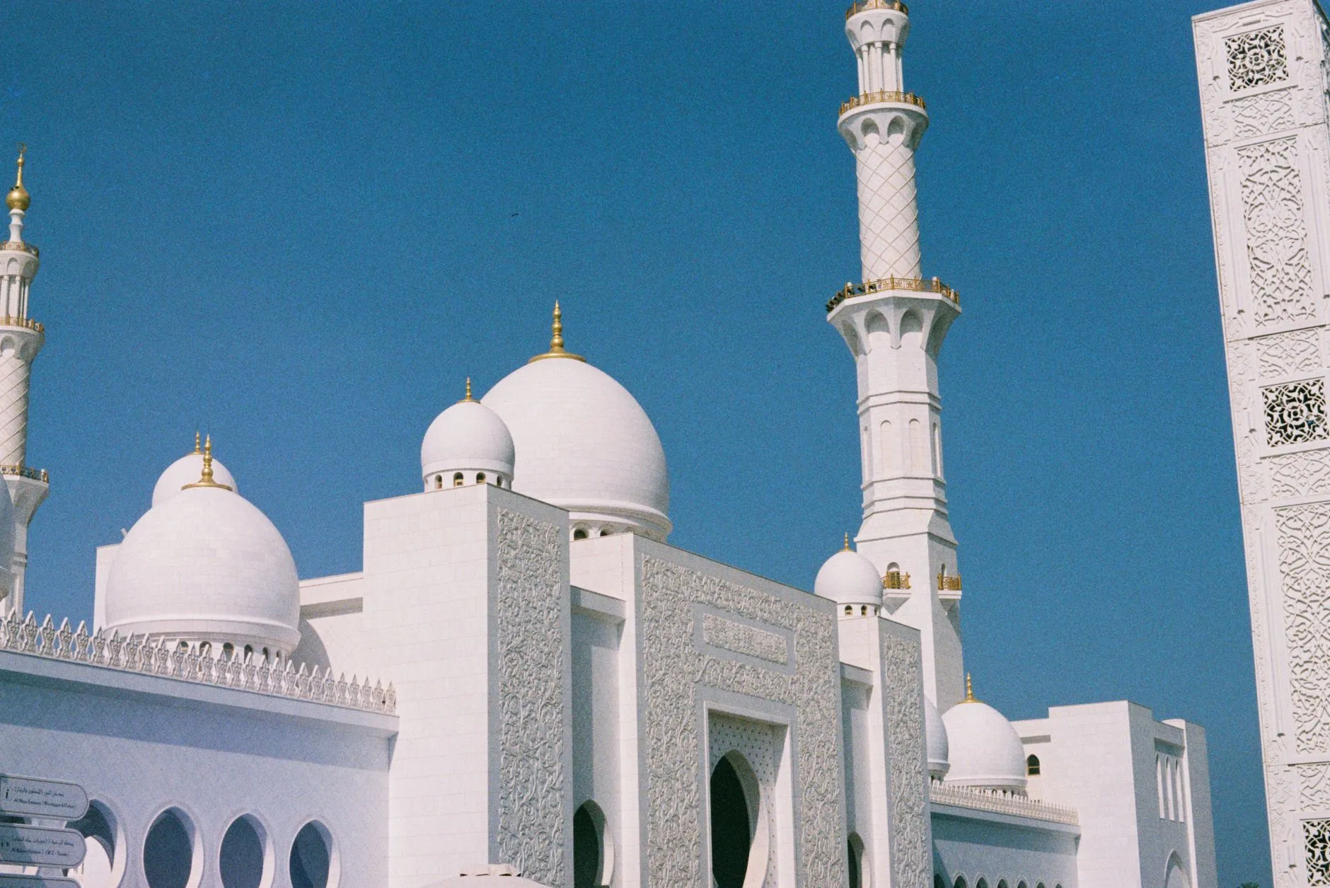 Sheikh Zayed Grand Mosque white domes and reflecting pool at dusk